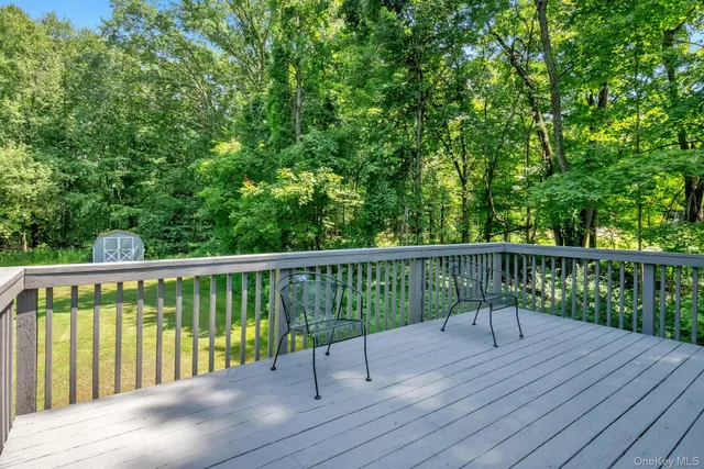 a view of balcony with wooden floor and fence