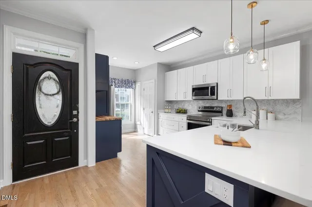 a kitchen with a refrigerator a stove a microwave and cabinets