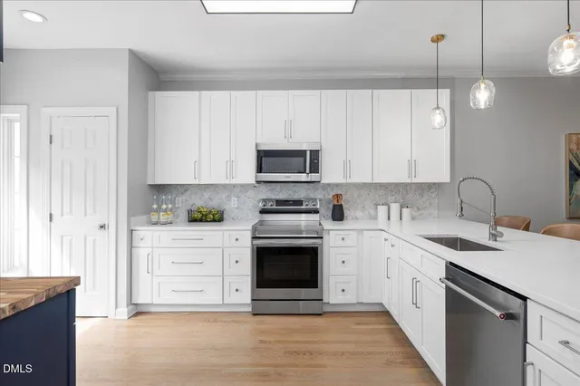 a kitchen with stainless steel appliances granite countertop a stove and a sink