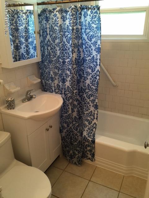 4773 Myrtlewood Road Jacksonville, FL 32210 - Photo 11 of 12 a bathroom with a sink a toilet and bathtub
