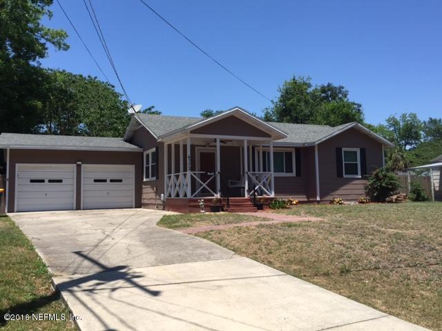 4773 Myrtlewood Road Jacksonville, FL 32210 - Photo 2 of 12 a front view of a house with yard and trees in the background