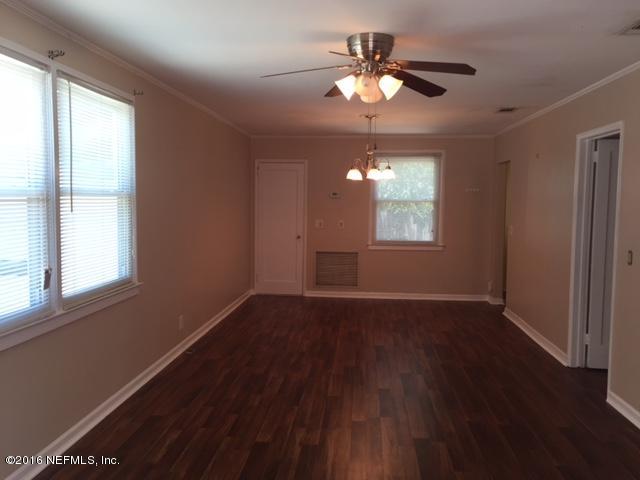 4773 Myrtlewood Road Jacksonville, FL 32210 - Photo 3 of 12 a view of an empty room with wooden floor and a window