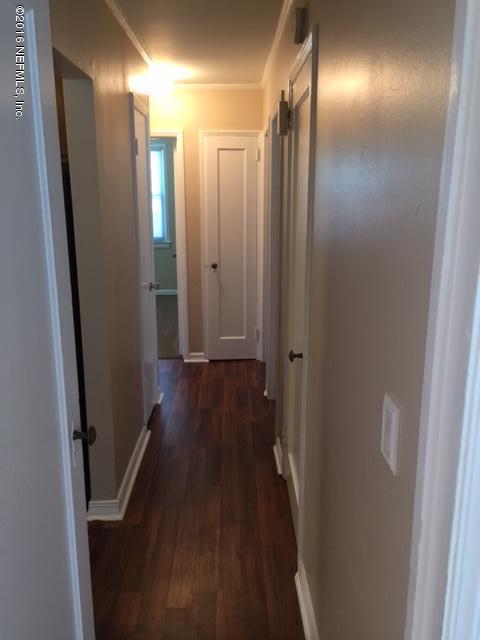4773 Myrtlewood Road Jacksonville, FL 32210 - Photo 4 of 12 a view of hallway with stainless steel appliances wooden floor