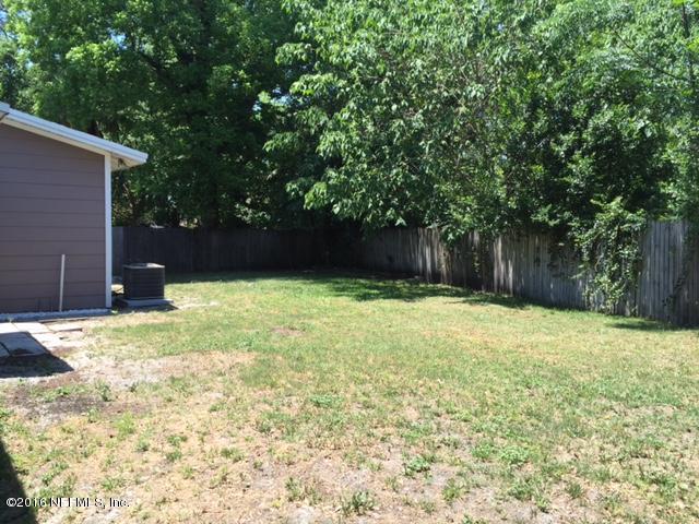 4773 Myrtlewood Road Jacksonville, FL 32210 - Photo 8 of 12 a swimming pool with wooden fence