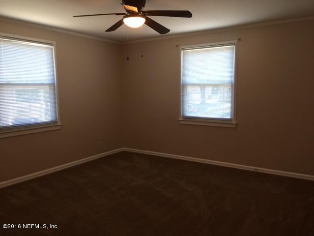 4773 Myrtlewood Road Jacksonville, FL 32210 - Photo 9 of 12 an empty room with a window and a fan
