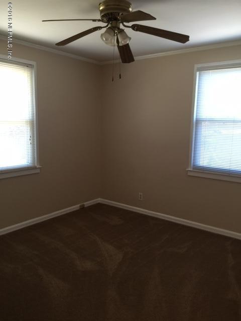 4773 Myrtlewood Road Jacksonville, FL 32210 - Photo 10 of 12 a view of an empty room with a window