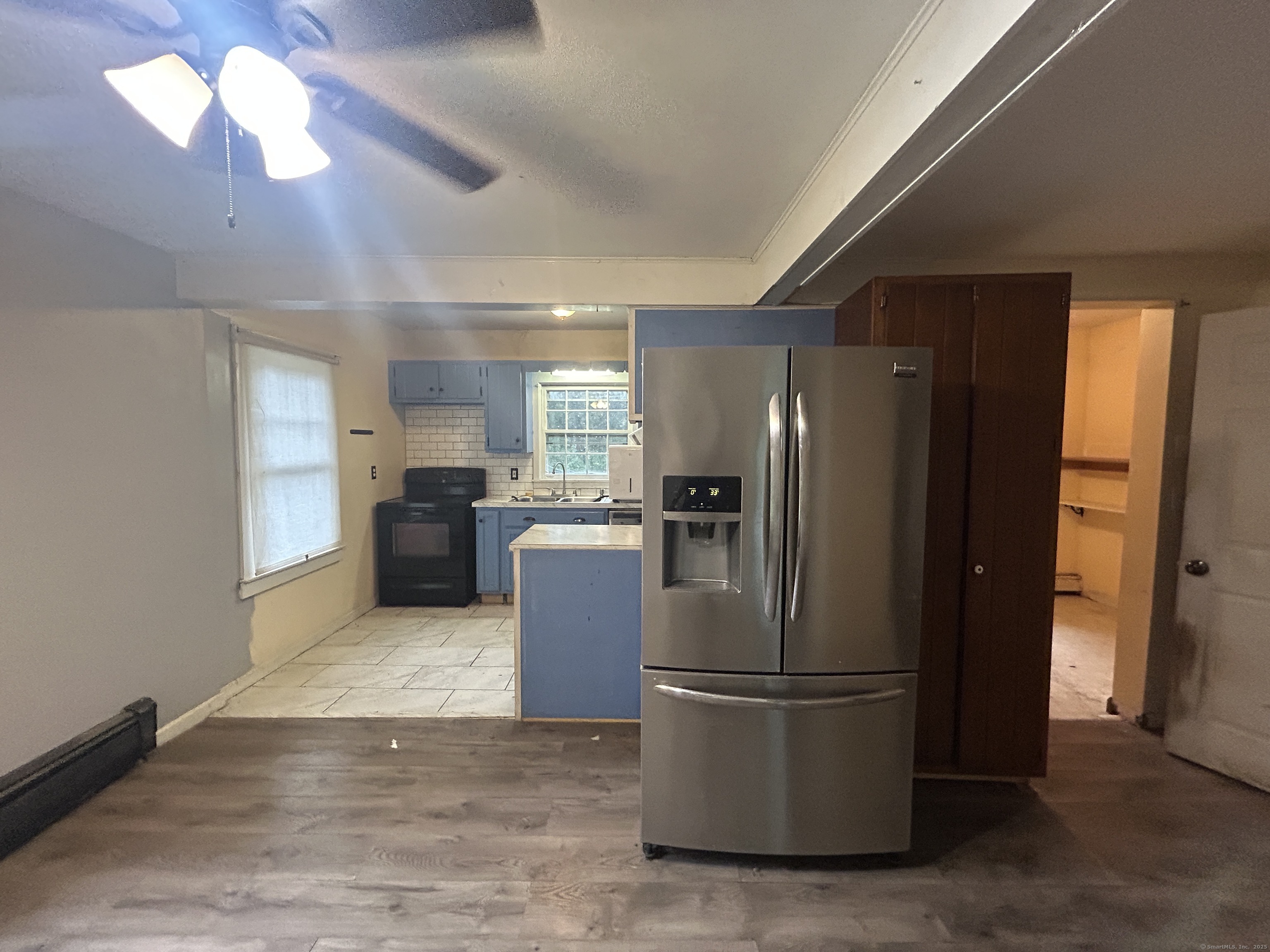 53 Falls Bashan Road East Haddam, CT 06469 - Photo 14 of 32 a kitchen with a refrigerator sink and cabinets