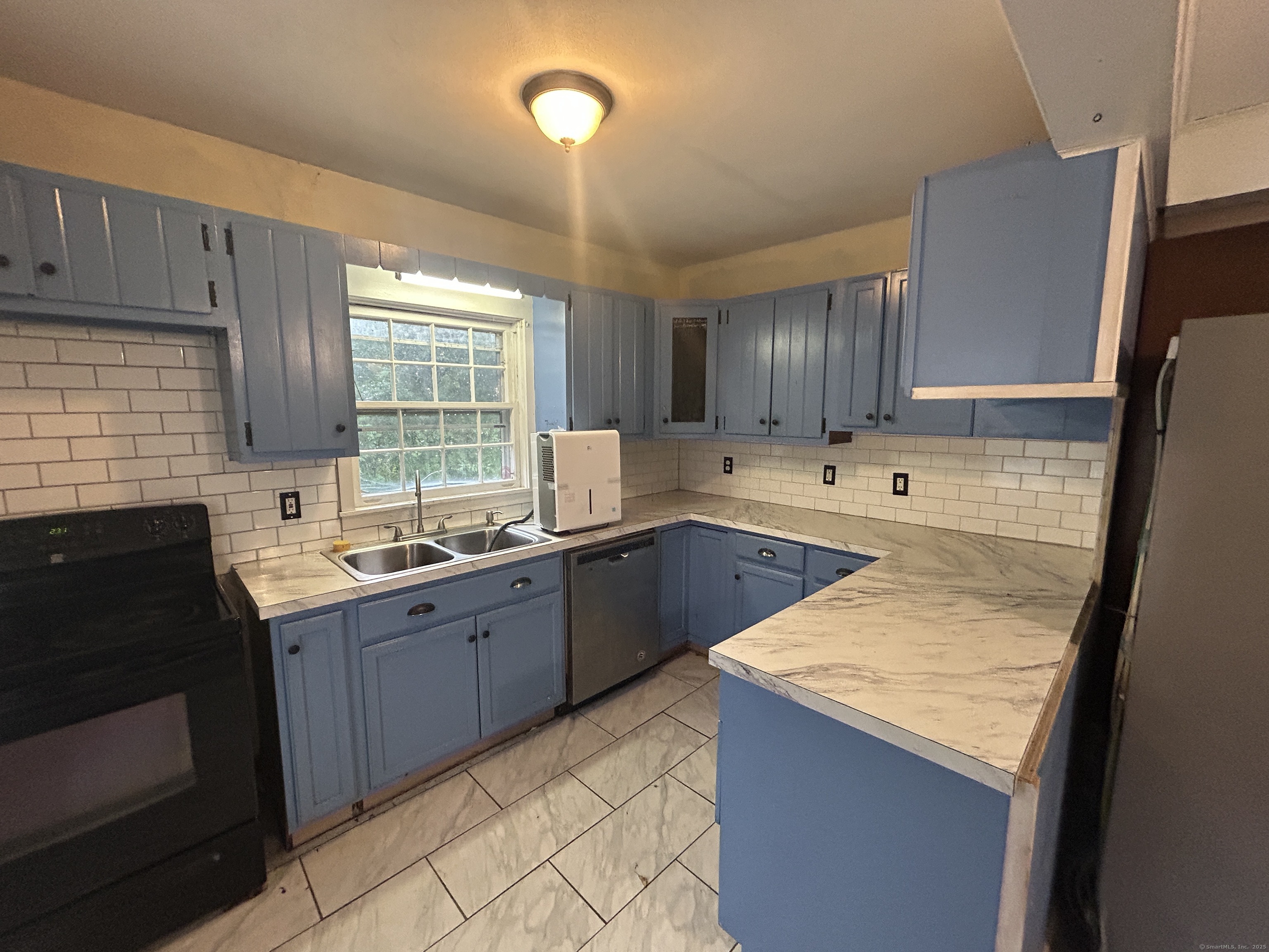 53 Falls Bashan Road East Haddam, CT 06469 - Photo 15 of 32 a kitchen with a sink stove and cabinets