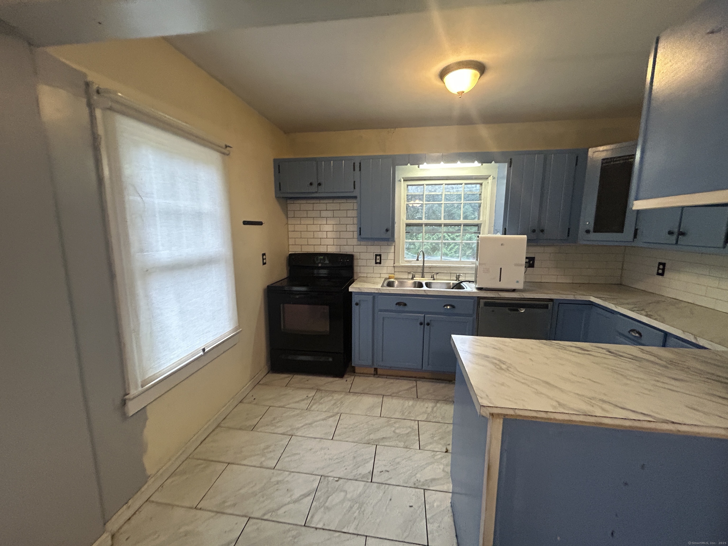 53 Falls Bashan Road East Haddam, CT 06469 - Photo 17 of 32 a kitchen with granite countertop a refrigerator a sink a stove top oven and cabinets