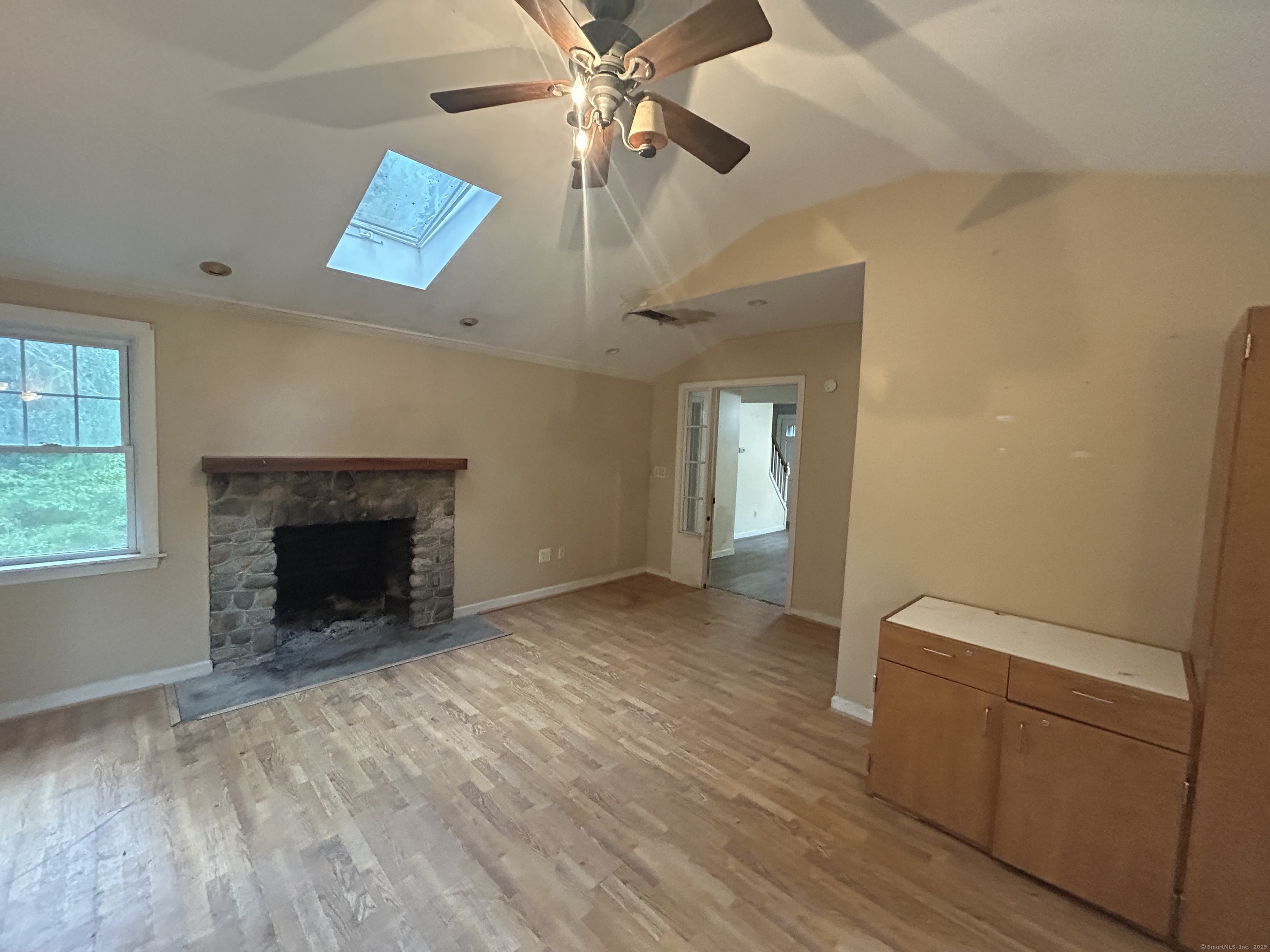 53 Falls Bashan Road East Haddam, CT 06469 - Photo 21 of 32 wooden floor fireplace and windows in an empty room