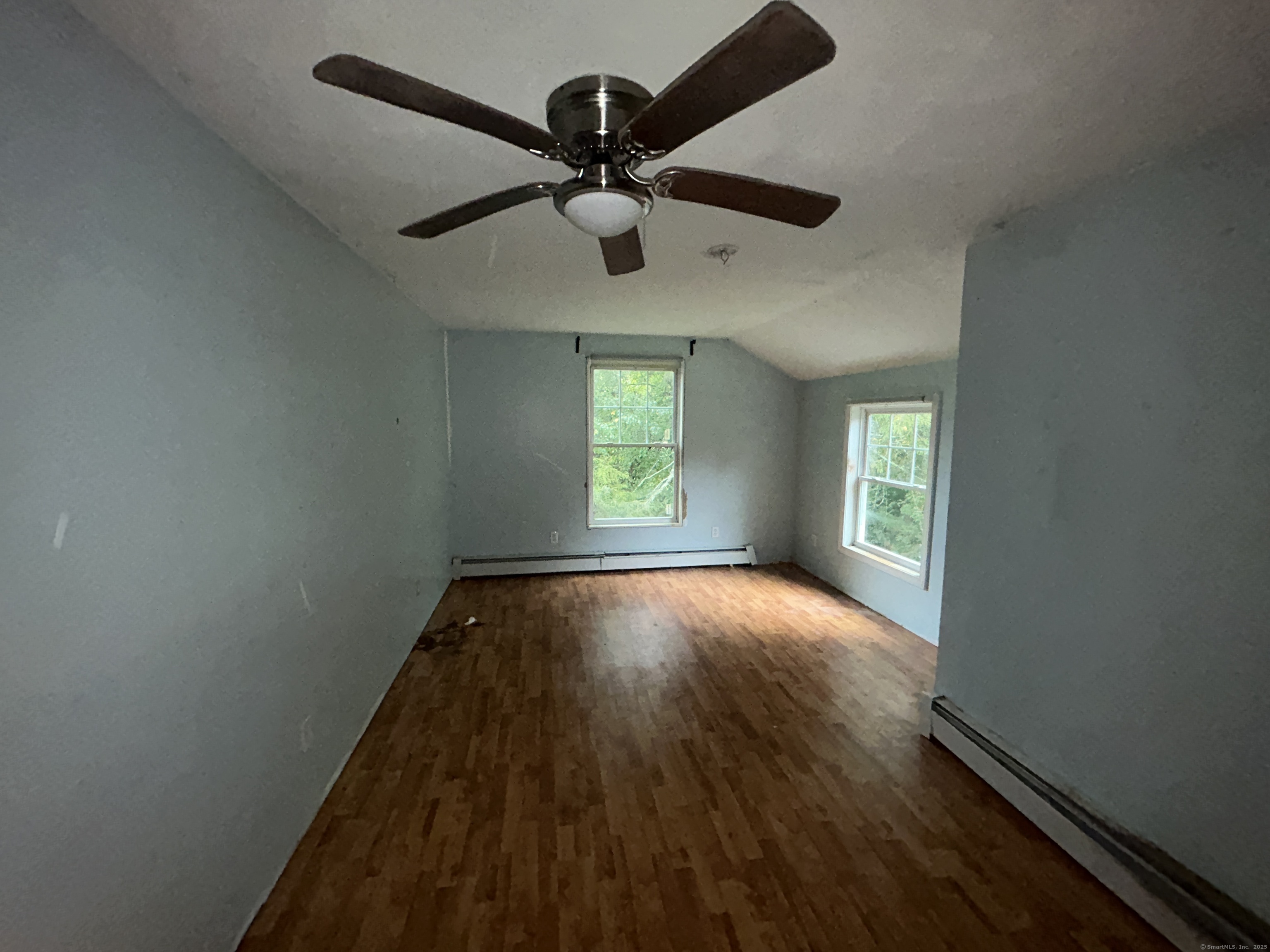 53 Falls Bashan Road East Haddam, CT 06469 - Photo 27 of 32 an empty room with wooden floor fan and windows