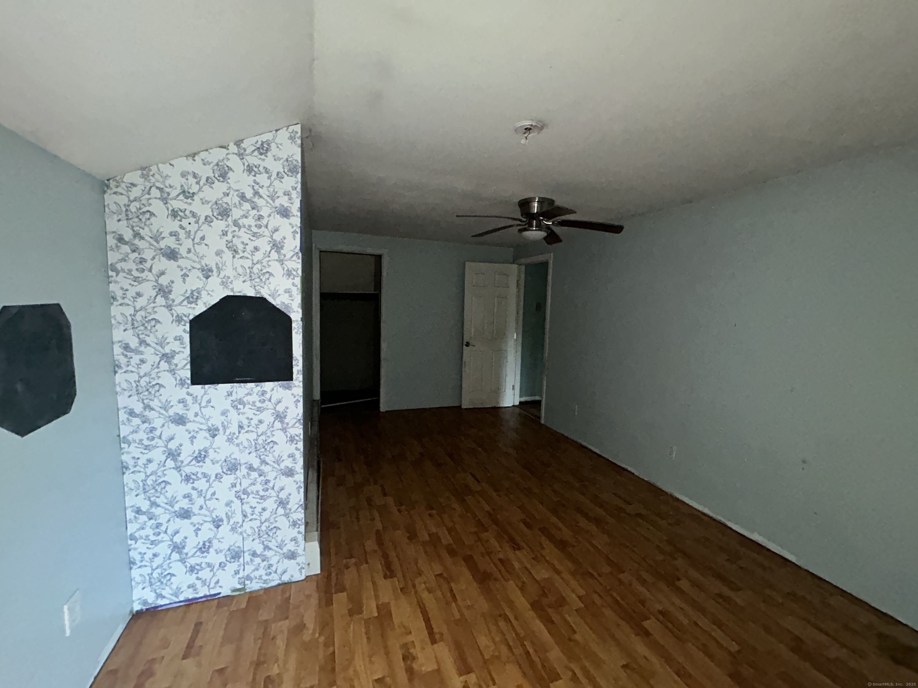 53 Falls Bashan Road East Haddam, CT 06469 - Photo 28 of 32 a view of an empty room with wooden floor and a fireplace