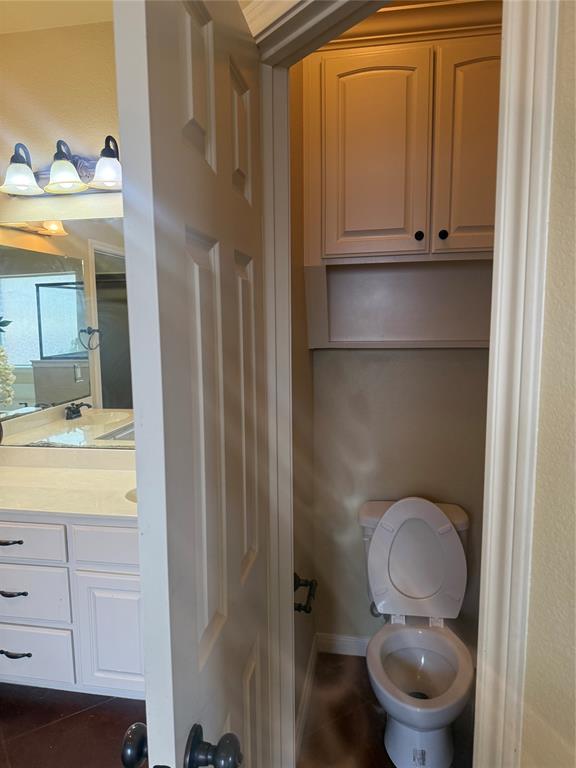 2524 Riders Way Woodway, TX 76712 - Photo 11 of 35 Bathroom featuring vanity and dark tile patterned flooring