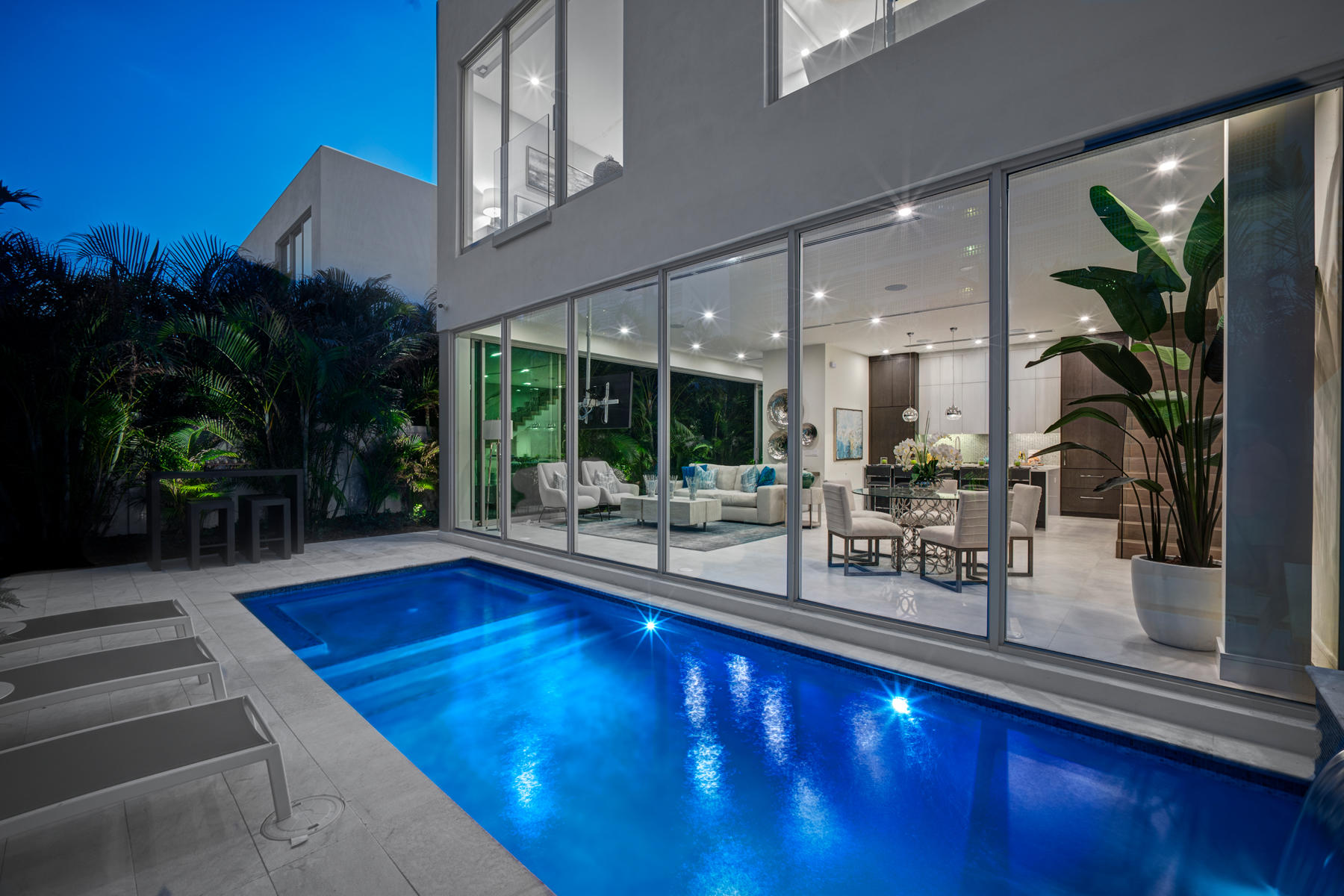 a view of swimming pool with outdoor seating and plants