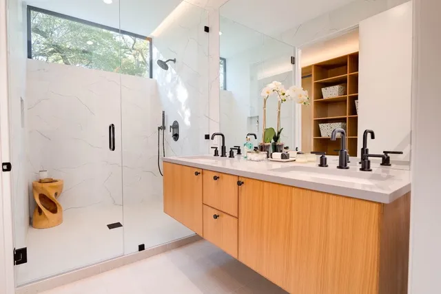 a bathroom with a tub sink and mirror