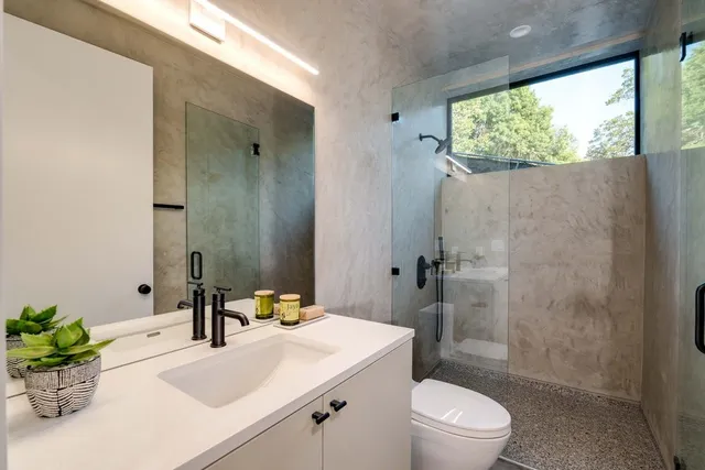 a bathroom with a sink toilet and shower
