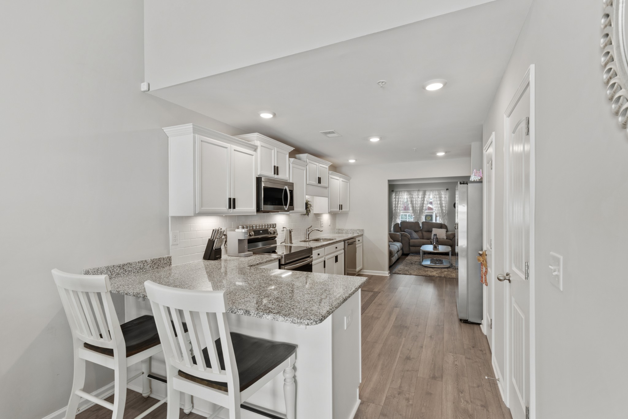 212 Addi Street Pleasant View, TN 37146 - Photo 12 of 37 a view of a dining room with furniture and a wooden floor