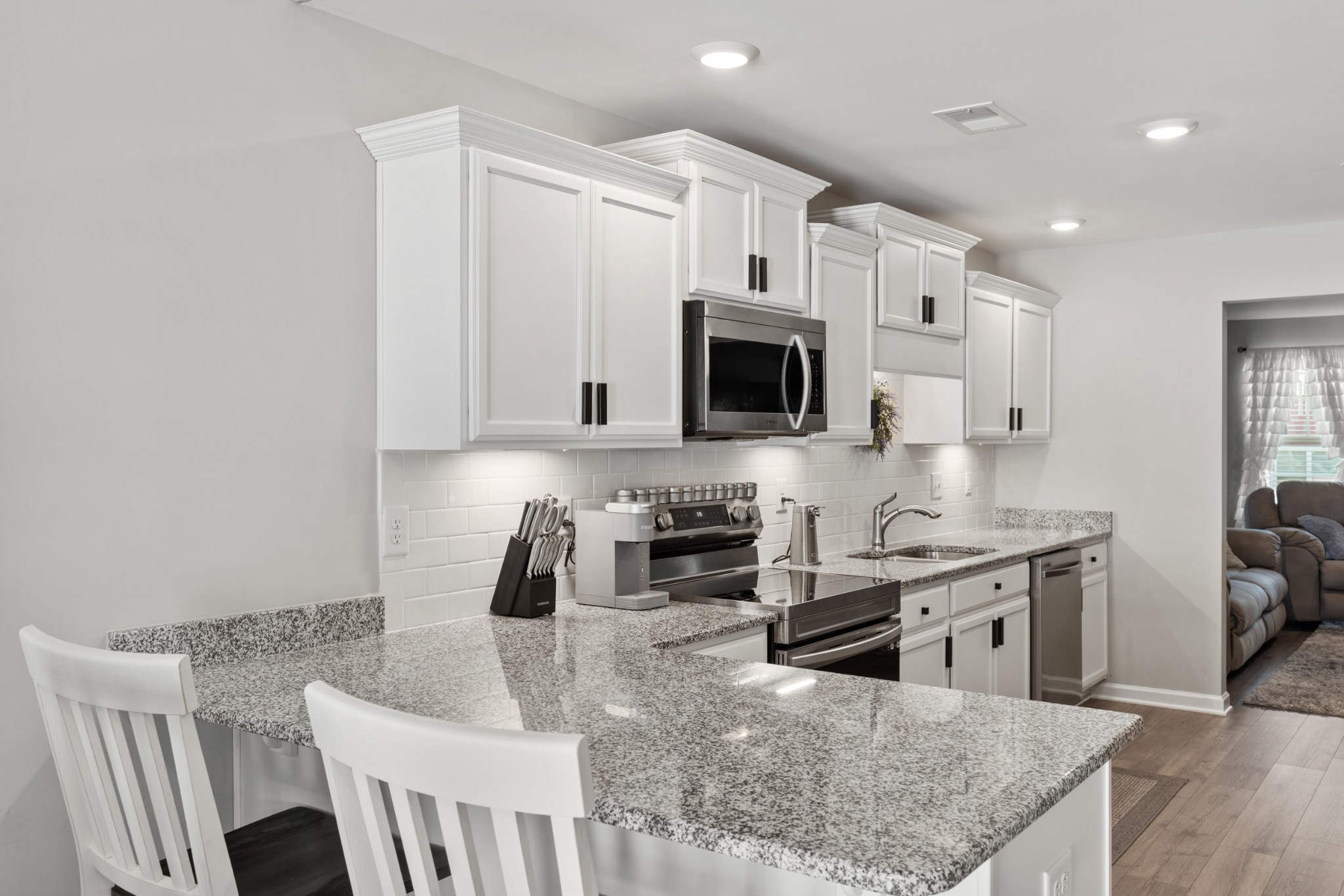 212 Addi Street Pleasant View, TN 37146 - Photo 13 of 37 a kitchen with stainless steel appliances granite countertop a sink a stove and a microwave