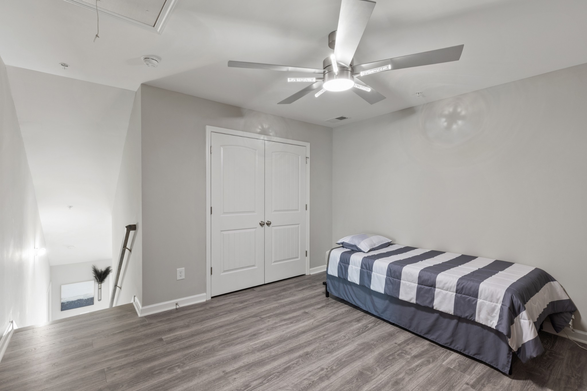 212 Addi Street Pleasant View, TN 37146 - Photo 26 of 37 a spacious bedroom with a bed and wooden floor