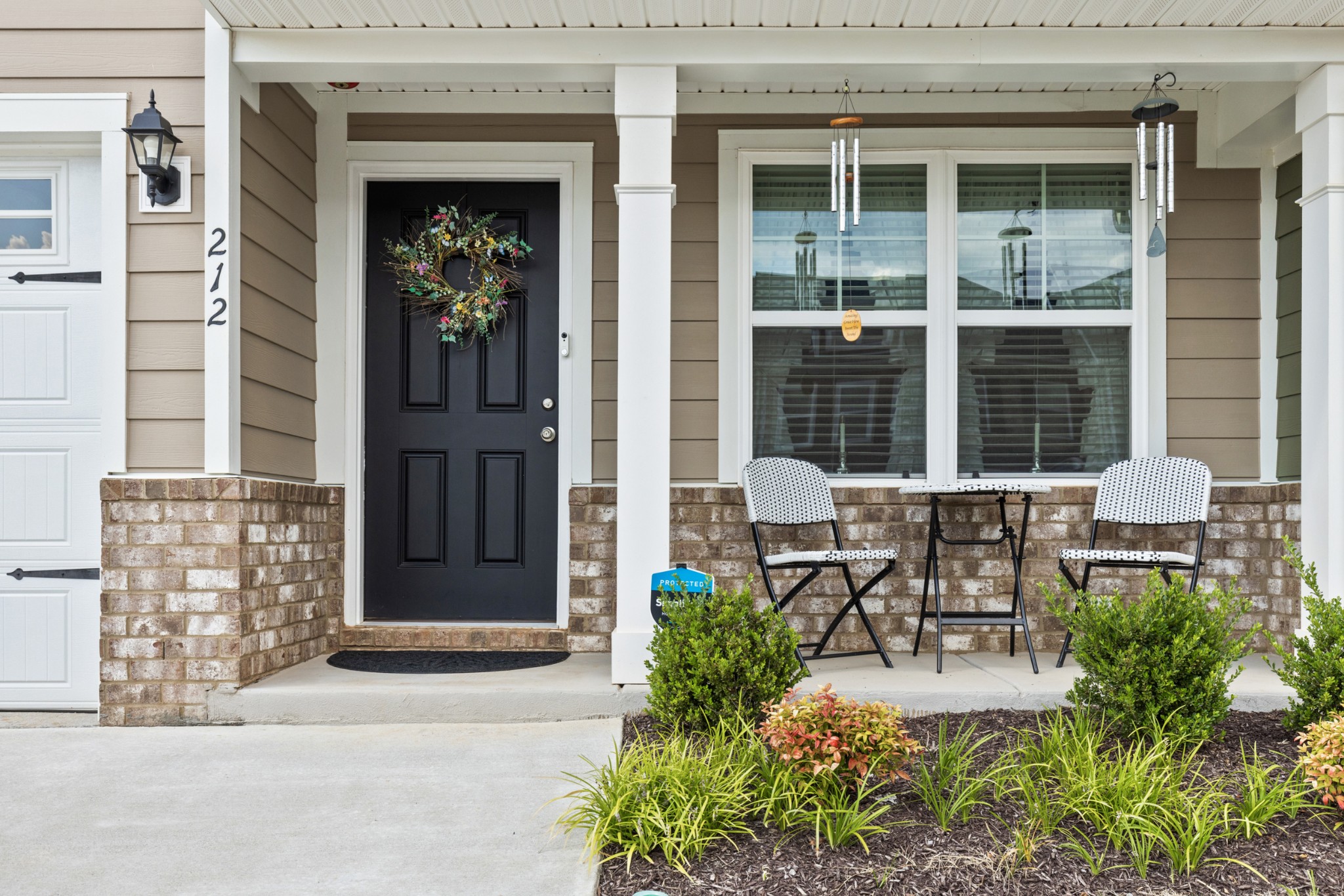 212 Addi Street Pleasant View, TN 37146 - Photo 3 of 37 a view of a patio that has table and chairs and potted plants in front of door