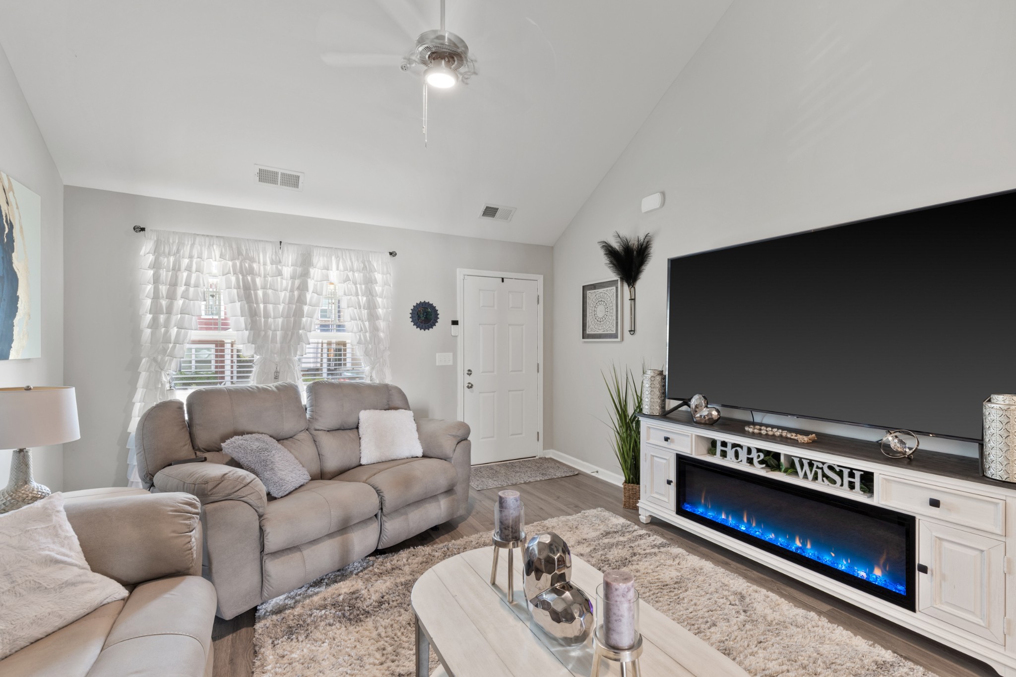 212 Addi Street Pleasant View, TN 37146 - Photo 8 of 37 a living room with furniture a flat screen tv and a window