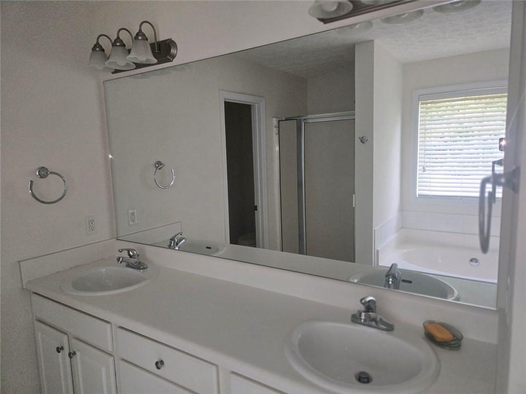 22 Windcrest Keep Covington, GA 30016 - Photo 22 of 32 a bathroom with a sink and a mirror