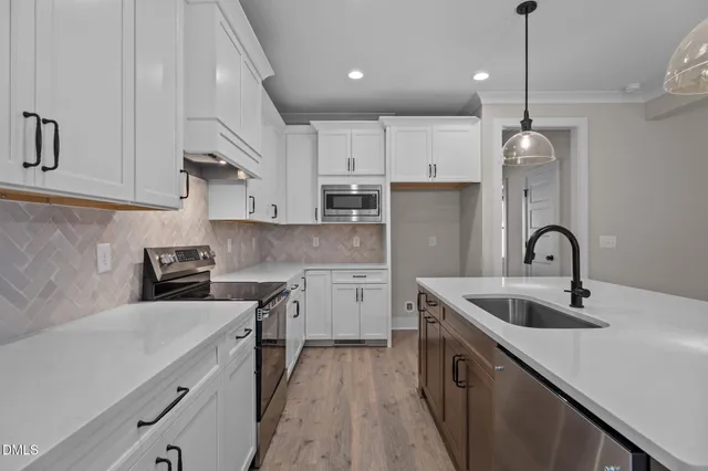 a kitchen with a sink stainless steel appliances and cabinets