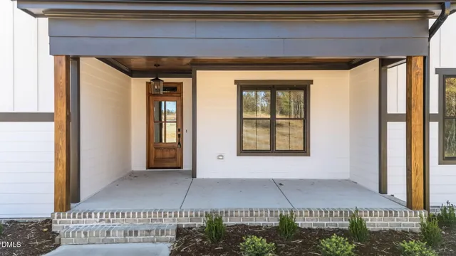a view of a balcony with wooden floor and glass door