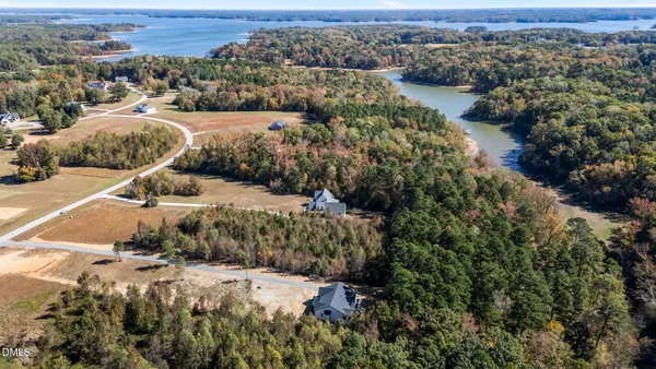 an aerial view of a houses with a yard