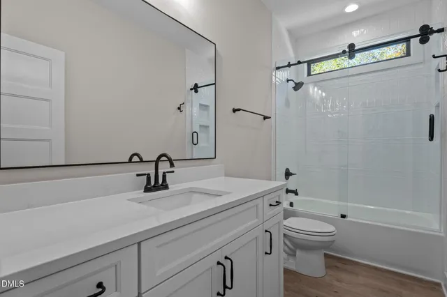 a view of a house with wooden deck and furniture