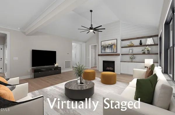 a living room with furniture a flat screen tv and a fireplace