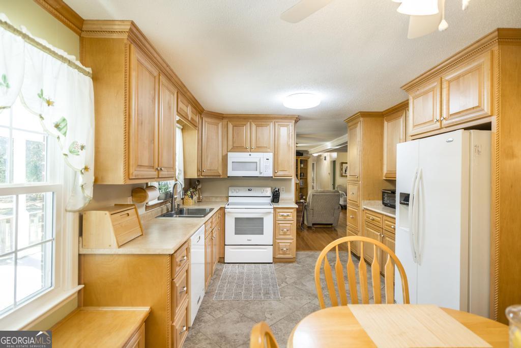 2574 Lower Hartley Bridge Road Byron, GA 31008 - Photo 14 of 45 a very nice looking open kitchen with stainless steel appliances kitchen island granite countertop a refrigerator a stove a sink dishwasher with a dining table and chairs