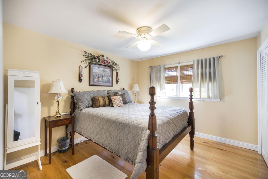 2574 Lower Hartley Bridge Road Byron, GA 31008 - Photo 21 of 45 a bedroom with a bed and a chandelier