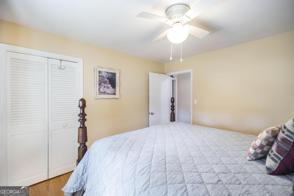 2574 Lower Hartley Bridge Road Byron, GA 31008 - Photo 22 of 45 a bedroom with a bed and a chandelier