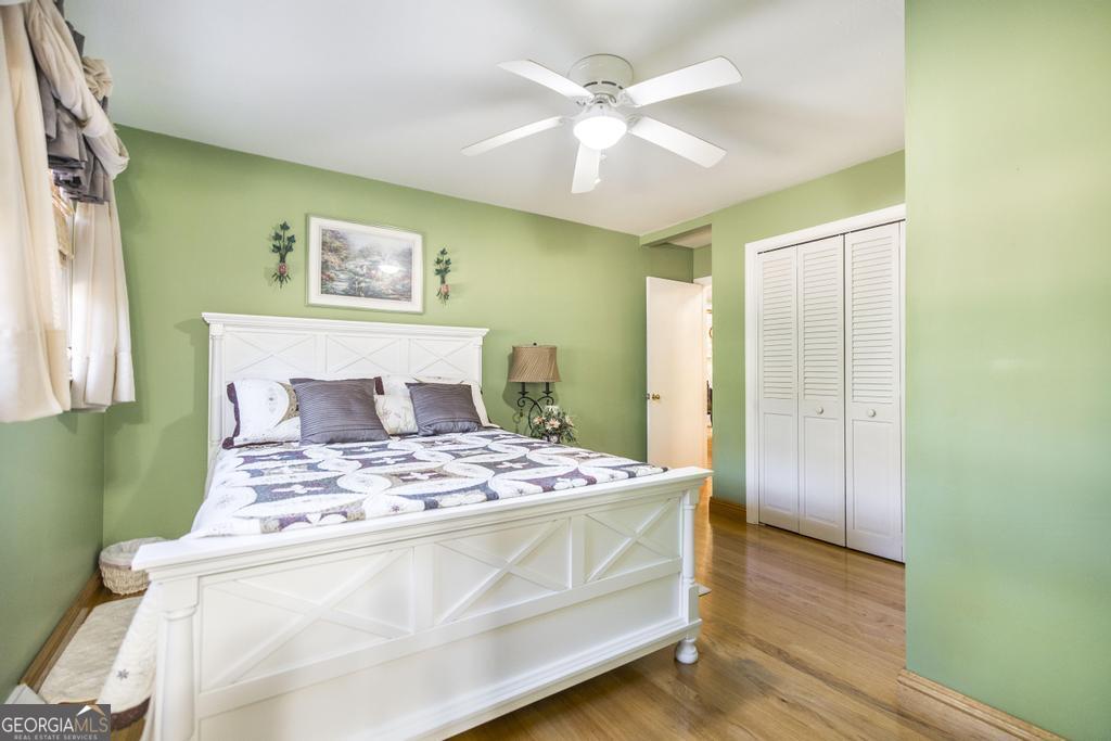 2574 Lower Hartley Bridge Road Byron, GA 31008 - Photo 24 of 45 a bedroom with a bed and a chandelier