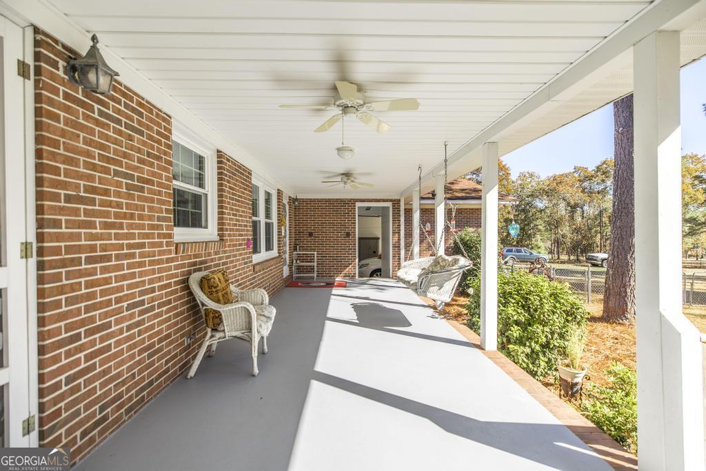 2574 Lower Hartley Bridge Road Byron, GA 31008 - Photo 26 of 45 a balcony with furniture and a potted plant