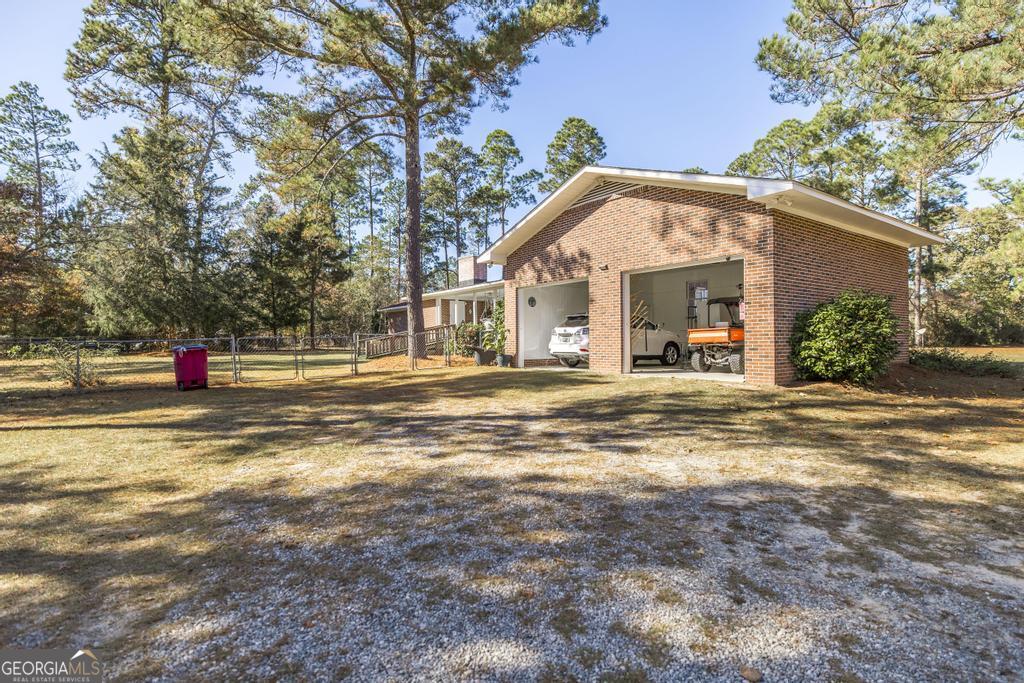 2574 Lower Hartley Bridge Road Byron, GA 31008 - Photo 27 of 45 a view of white house with a swimming pool