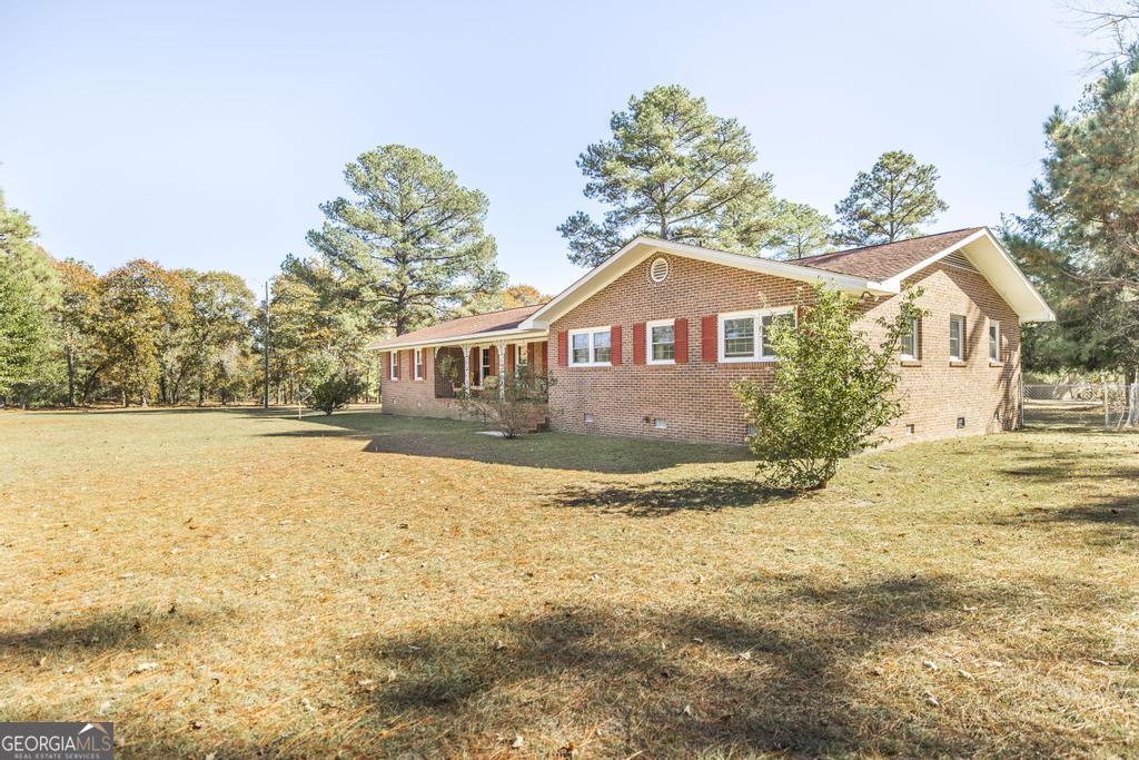 2574 Lower Hartley Bridge Road Byron, GA 31008 - Photo 3 of 45 a front view of a house with a yard