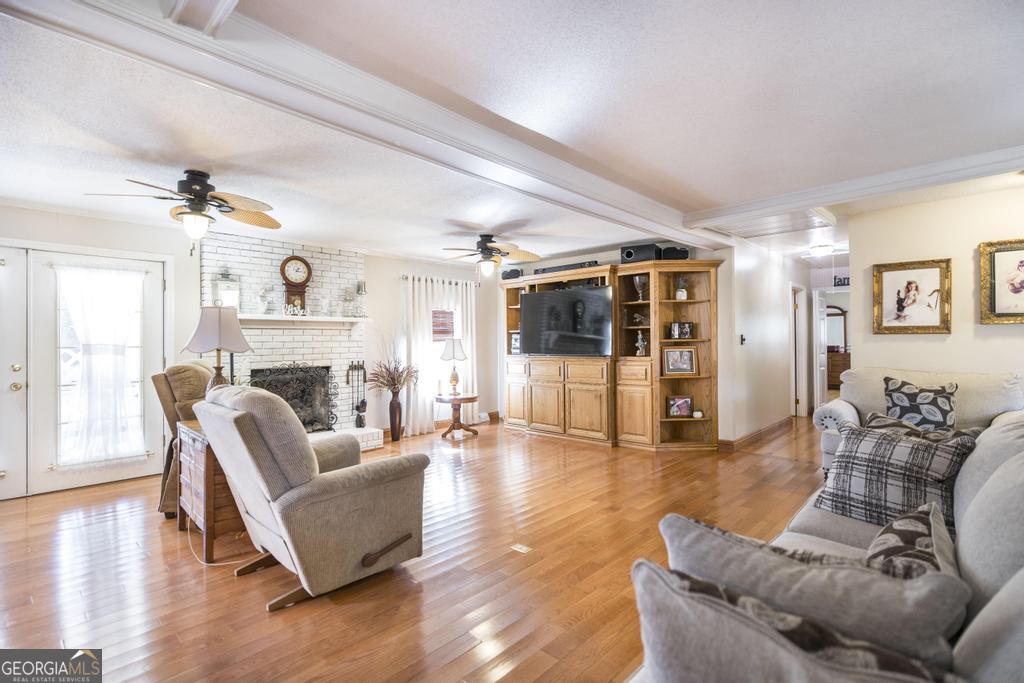 2574 Lower Hartley Bridge Road Byron, GA 31008 - Photo 7 of 45 a living room with furniture and a fireplace