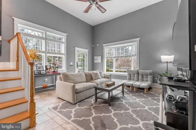 a kitchen with kitchen island a dining table chairs and a window