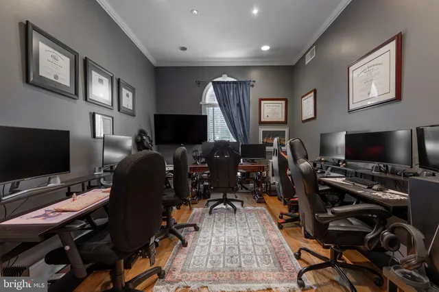 a view of a kitchen with stainless steel appliances granite countertop a sink and a stove with wooden floor