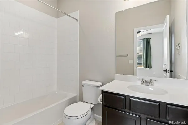 a bathroom with a sink toilet vanity and shower