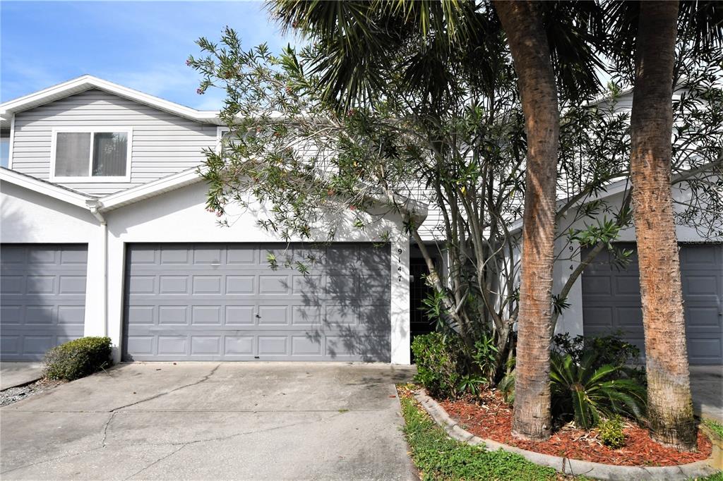 9147 Jake's Path Largo, FL 33771 - Photo 1 of 1 Front elevation with mature tropical landscaping
