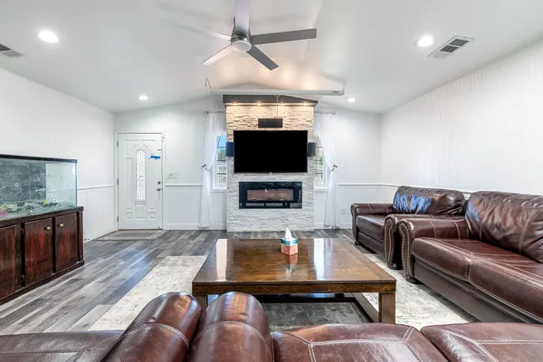 a living room with furniture and a flat screen tv