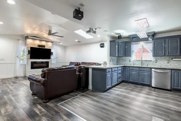 a large kitchen with stainless steel appliances granite countertop a sink and a stove