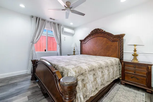 a bedroom with a bed and a chandelier