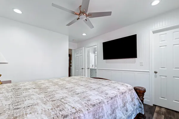 a bedroom with a bed and a flat screen tv