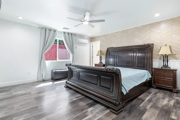 a bedroom with a bed and a chandelier