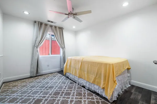 a bedroom with a bed and a window