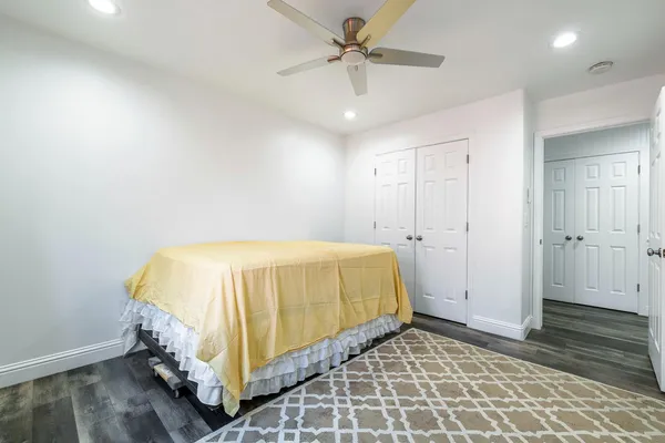 a spacious bedroom with a bed and a chandelier